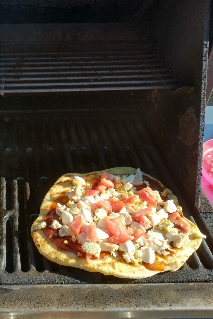 two pizzas on a bbq