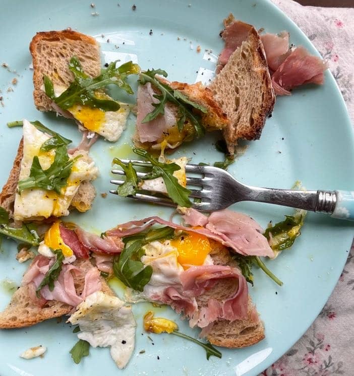 egg toast lunch being cut up with a fork