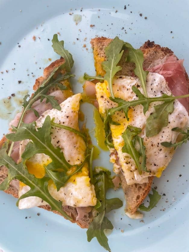 open faced arugula, egg and prosciutto sandwich