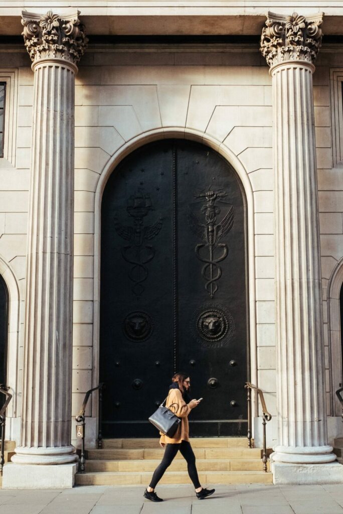 woman walking by college building