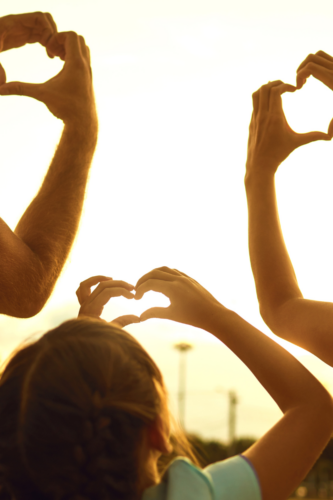 Family making heart shape with hands