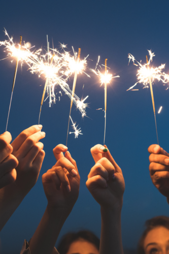 sparklers lit and being held in the air