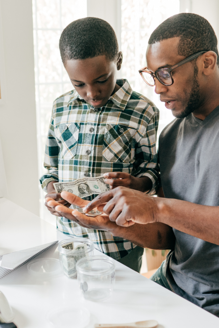 Dad teaching son how to count and save money