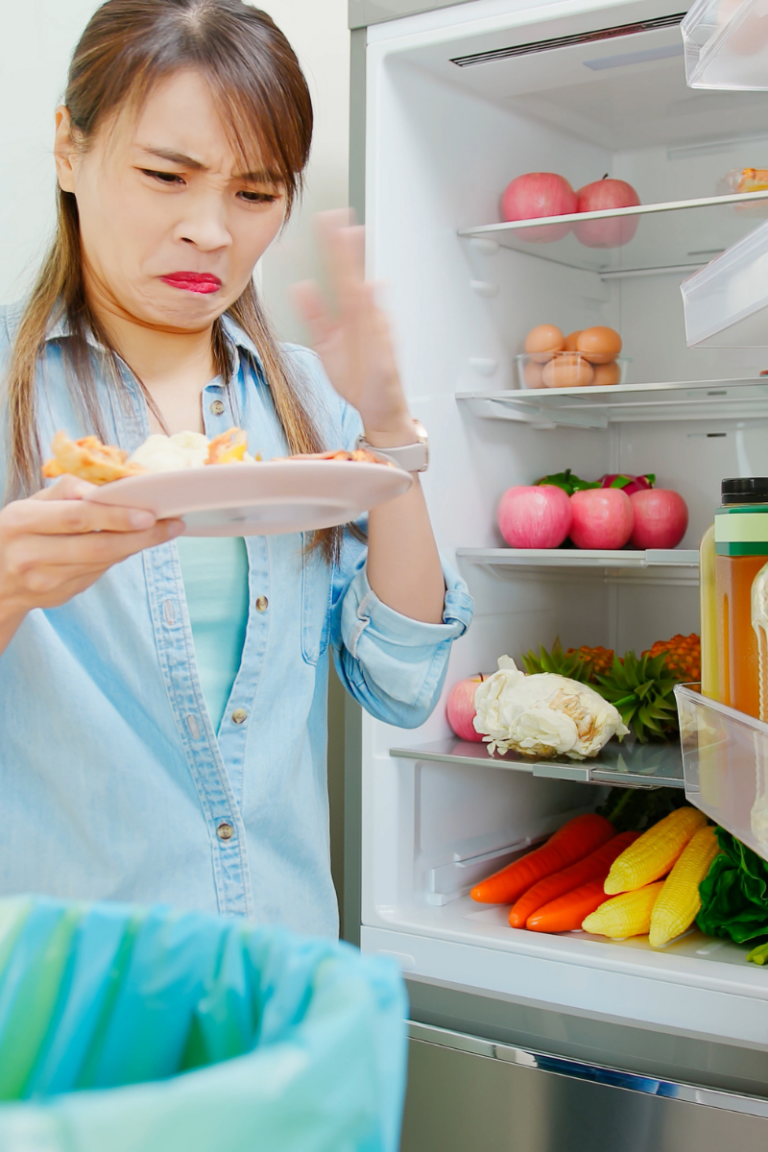 woman going through fridge foods