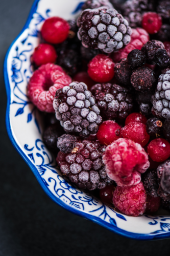 frozen berries in blue bowl