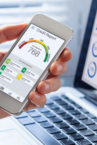 app on a phone with a credit score shown under a gauge