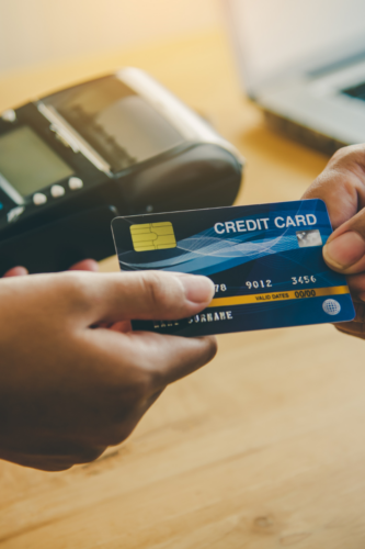person using credit card to make a purchase