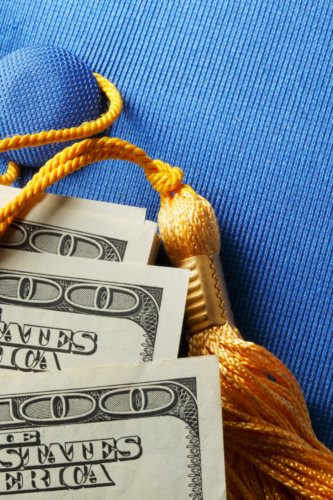 blue graduation hat with 3 100 dollar bills on it