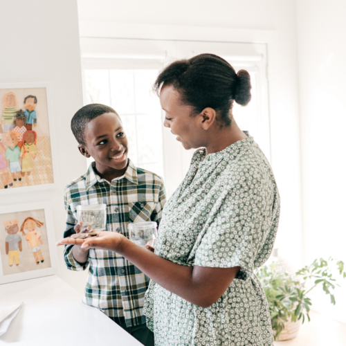 small boy and his mom saving money together