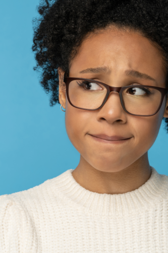 woman wearing glasses looking up and feeling awkward thinking about finances